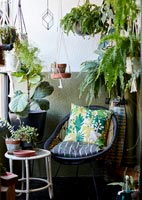 Garden furniture on terrace with plants in containers 