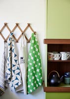 Tea towels and apron hung up in kitchen 