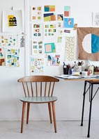 Vintage chair and colour swatches on wall of study 