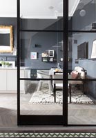 View through glass door to modern kitchen-diner 