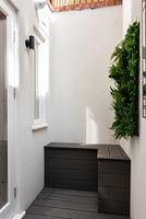 Tiny courtyard with built in storage seating 