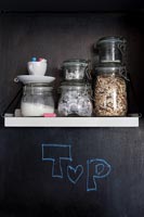 Blackboard wall in kitchen - storage jars on shelf 