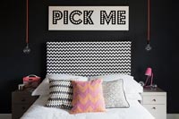 Modern bedroom with Pick Me sign above the bed
