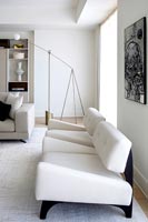 Modern white armchairs in living room 