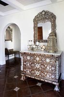 Ornate chest of drawers in country hallway