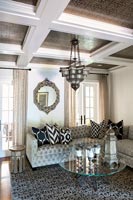 Eclectic living room with ornate ceiling panels 