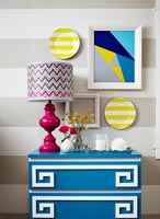 Colourful patterned accessories and chest of drawers 