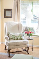 Floral cushion on classic armchair 