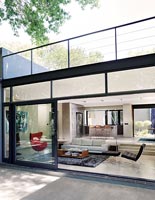 View into contemporary open plan house through open patio doors 
