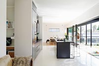 Contemporary kitchen with open bi-fold doors 