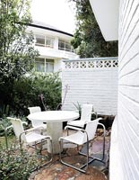 White garden furniture on small terrace 