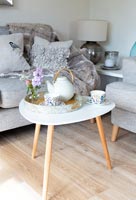 Tray of tea on small table in modern living room 