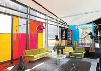 Colourfully painted windows in open plan living space 