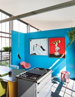 Colourful compact kitchen in industrial space 