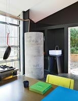 Concrete cylinder in modern open plan industrial kitchen 
