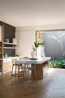 Island in contemporary kitchen-diner with courtyard 