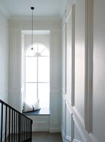 Window seat on classic staircase landing 