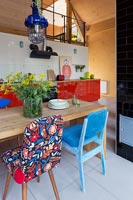 Wooden table and colorful vintage chairs