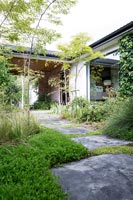 Modern house and garden with slate path 