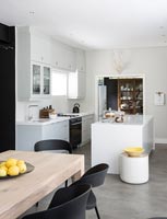 Modern monochrome kitchen with concrete flooring 