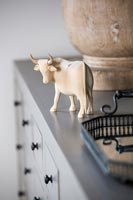 Wooden carving of oxen on sideboard 