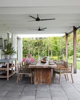 Covered terrace with large wooden dining area 
