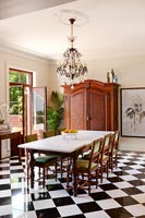 Black checkerboard floor in classic dining room 