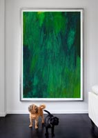 Pet dogs standing in front of artwork