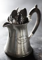 Close up cutlery in silver jug