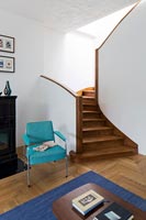 Wooden stairs and turquoise armchair