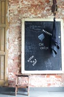 Chalk board on exposed brick wall 