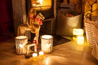 Candles and lanterns in front of wood burner 