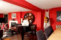 Red living room with piano 