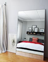 Modern bedroom with large mirror 