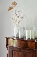 White glass vases on antique wardrobe