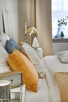 Modern bedroom - tiny white Christmas decoration on bedside table 