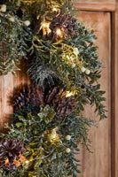 Detail of Christmas wreath on wooden door 