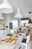 Modern country kitchen with table full of cakes at Christmas 