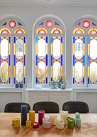 Stained glass windows and period details in modern dining room 