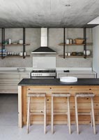 Modern kitchen with wooden island and concrete floor 