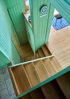 Overview of staircase with green painted wooden walls 