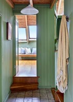 Country hallway with green painted wooden walls 