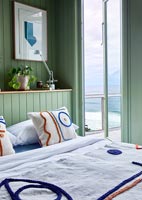 Embroidered bedspread in coastal bedroom 