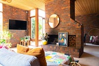 Modern living room with fireplace and exposed brickwork walls 