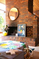 Modern living room with fireplace and exposed brickwork walls 