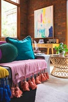 Modern living room with colourful cushions on sofa 