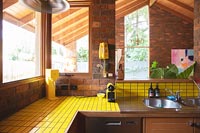 Yellow tiling in wooden kitchen 
