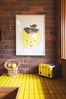 Yellow tiling on worktop of modern kitchen 
