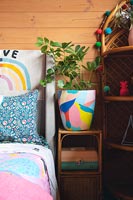 Colourful childrens room with painted pot plant 