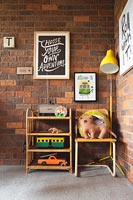 Shelves, toys and chair in corner of childrens room 